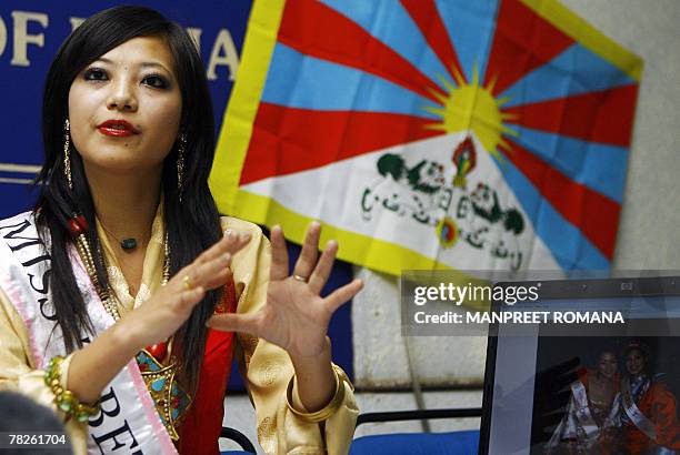 Miss Tibet 2006 Tsering Chungtak gestures as she answers a question during a press conference in New Delhi, 05 December 2007. A Tibetan contestant...