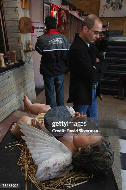 Hand painted sculpture by elusive British graffiti artist Banksy called "The Death Of Christianity" shows a cherub bleeding from a wound made by a...