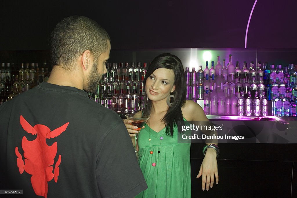 Man and woman standing at a bar counter