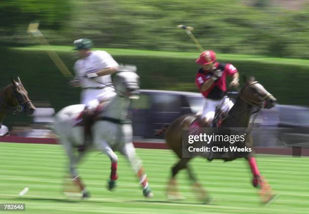 Actor Tommy Lee Jones hits a "back shot" as he competes with his San Saba polo team at the Santa Barbara Polo & Racquet Club July 30, 2000 in Santa...