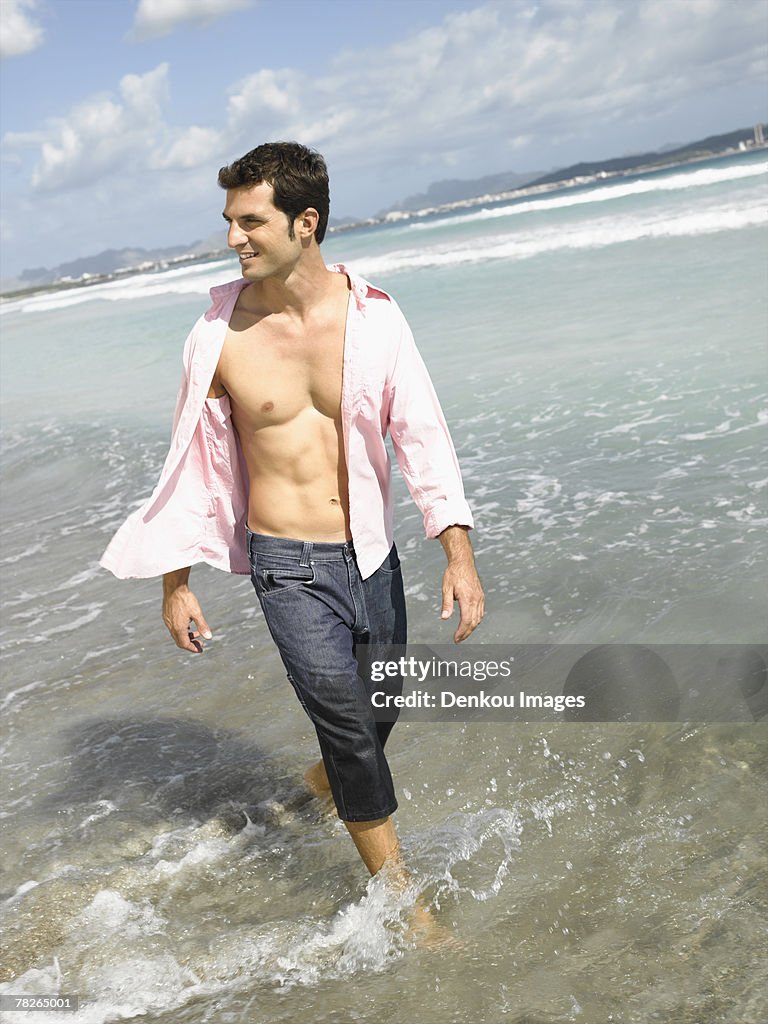 Mid adult man walking on the beach