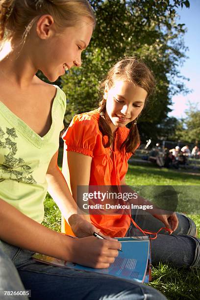 teenage girls reading a magazine. - magazine retreat day 2 stock pictures, royalty-free photos & images