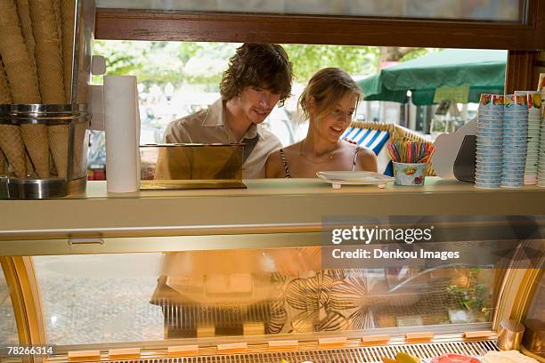 a couple at an ice cream stand - ice cream counter stock-fotos und bilder