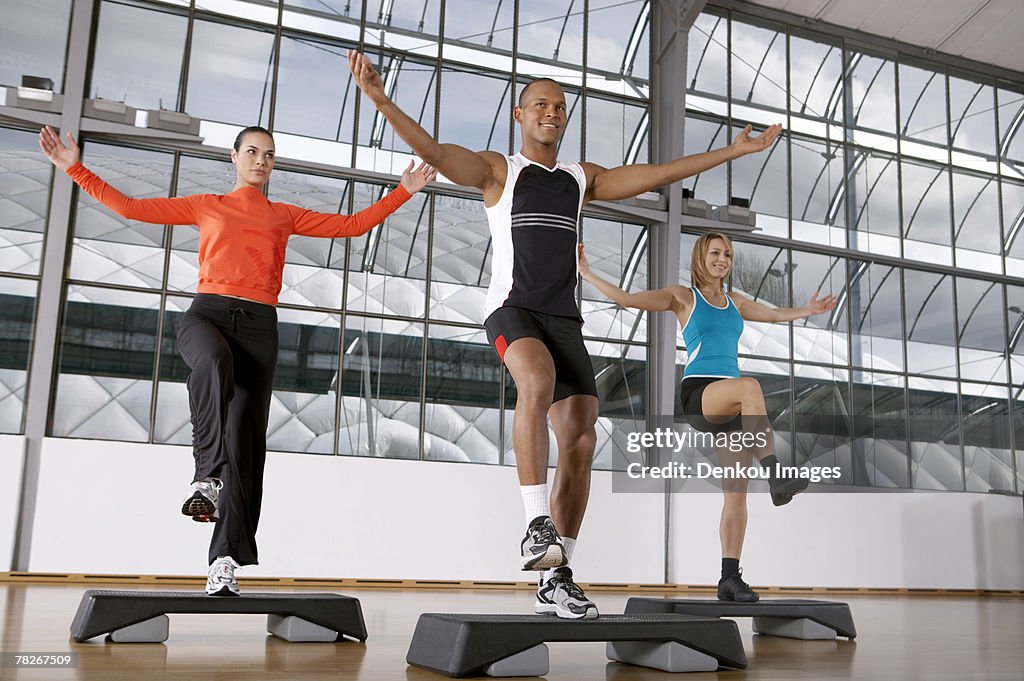 People doing step aerobics.