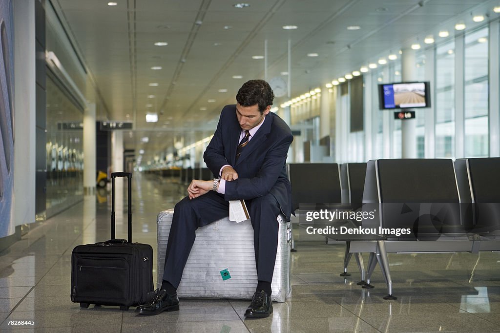 A businessman waiting in the departure lounge.