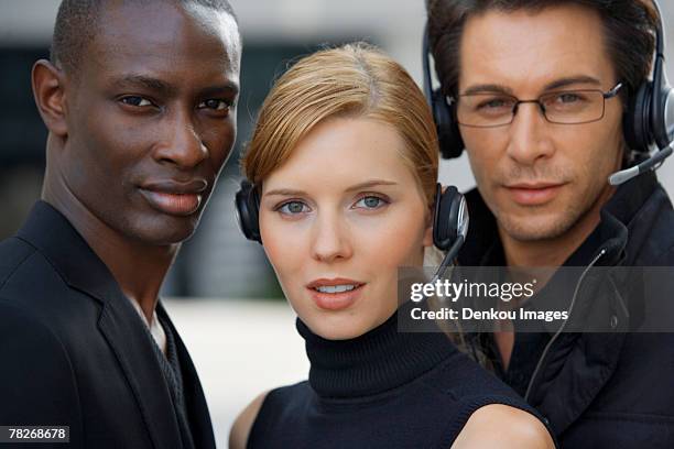 three business people standing together. - off the shoulder coat stock pictures, royalty-free photos & images