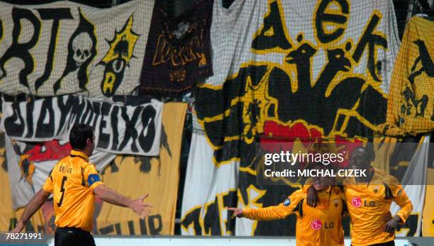 Tamanda Nsaliwa of AEK Athens celebrates with team-mates Alves Regufe and Traianos Dellas after scoring against Mlada Boleslav during their UEFA Cup...