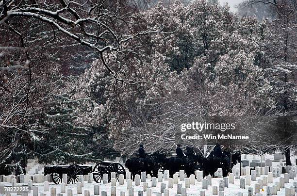 Caisson team at Arlington National Cemetery returns to Fort Myer during the first snowfall of the year December 5, 2007 in Arlington, Virginia. The...