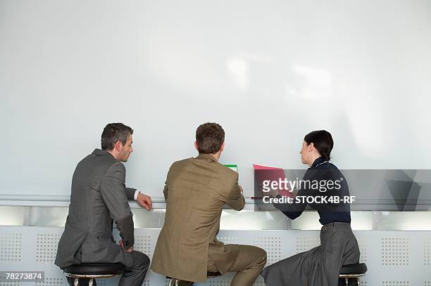 three businesspeople having a meeting - rf business stock pictures, royalty-free photos & images
