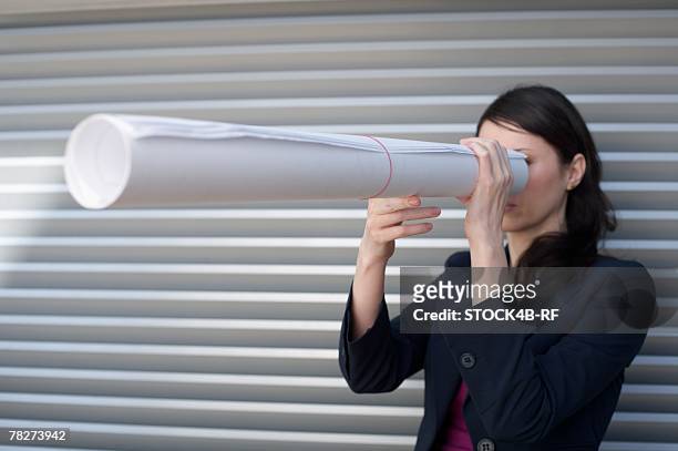 businesswoman looking through paper roll - b roll stock pictures, royalty-free photos & images