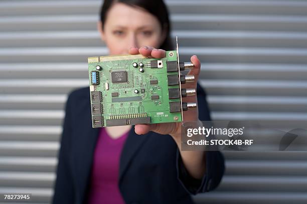 businesswoman holding a sound card - printed circuit b stock pictures, royalty-free photos & images