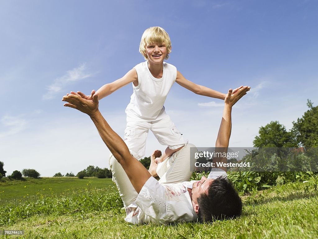 Father playing with son, outdoors