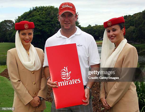 Dylan Campbell is presented with his prize by members of the Emirates promotional crew after winning the Emirates "nearest to the pin" competition at...