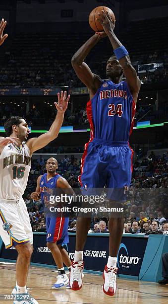 Antonio McDyess of the Detroit Pistons takes a shot over Paja Stojakovic of the New Orleans Hornets on December 5, 2007 at the New Orleans Arena in...