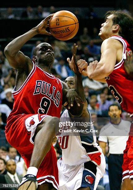 Luol Deng of the Chicago Bulls draws a foul from Raymond Felton of the Charlotte Bobcats during the second half at Bobcats Arena on December 5, 2007...