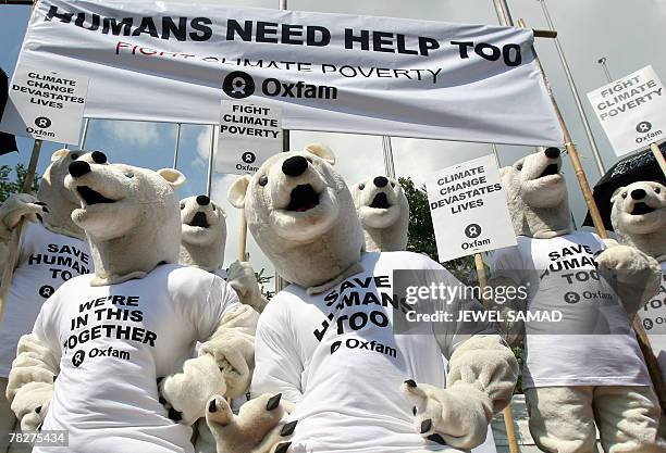 Activists dressed as "polar bears" shout the slogan "humans need help too" during a demonstration at the venue of the UN Climate Change Conference...