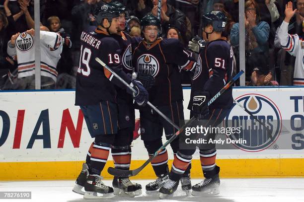 Marty Reasoner, Tom Gilbert, Robert Nilsson and Kyle Brodziak the Edmonton Oilers celebrate a goal against the Pittsburgh Penguins at Rexall Place on...