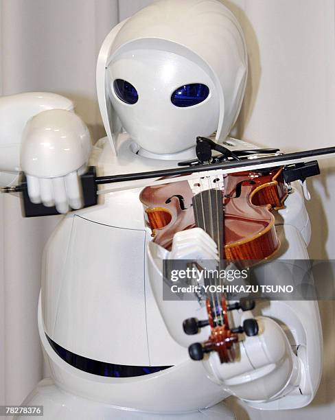 Japanese auto giant Toyota Motor unveils their new violin-playing robot at the company's showroom in Tokyo, 06 December 2007. Toyota unveiled three...