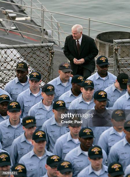 Secretary of Defense Robert M. Gates arrives on the flight deck of the USS Vicksburg to conduct a re-enlistment ceremony, December 6 in Manama,...