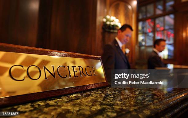 Two concierges man the front desk at the Savoy Hotel on December 6, 2007 in London. Some of the fixtures and fittings are to be auctioned before the...