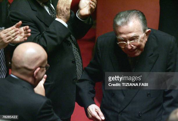Life senator and former Italian Prime Minister Giulio Andreotti receives applauses by the opposition after voting against the government on a...