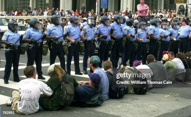 Protesters sit on the ground and lock arms causing a temporary standoff with Philadelphia Police during a protest in support of convicted cop killer...