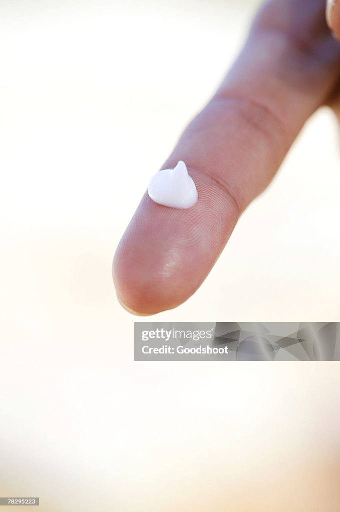 Drop of cream on a finger