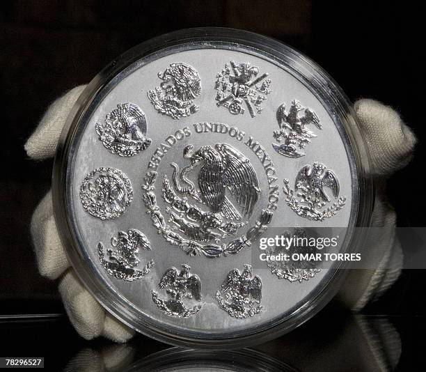 The obverse of commemorative silver coin "Calendario Azteca " with the Mexican shield is shown during the presentation ceremony at the Anthropology...