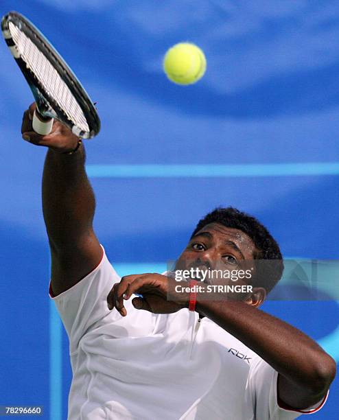 Malaysian tennis player Kanagaraj Balakrishnan hits a serve during 24th Southeast Asian Games team event, in Korat, 07 December 2007, against Thai...