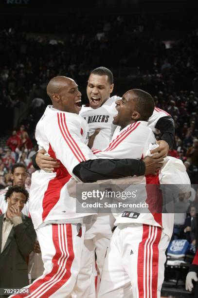 Travis Outlaw, Brandon Roy and Martell Webster of the Portland Trail Blazers get pumped before a game agienst the Miami Heat during a game on...