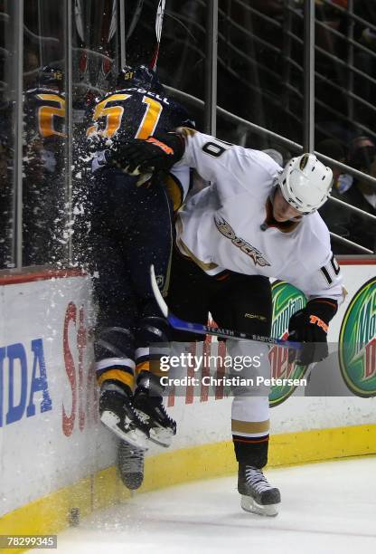 Corey Perry of the Anaheim Ducks checks Brian Campbell of the Buffalo Sabres into the boards during the NHL game at Honda Center on December 5, 2007...