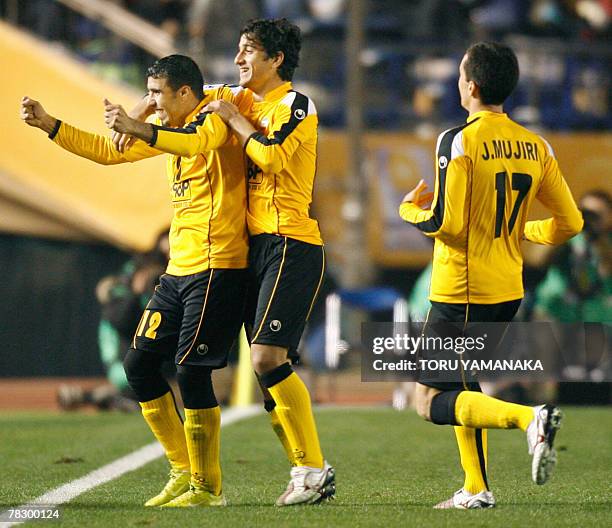 Midfielder Abdul Wahab Abu Al Hail of Iranian club Sepahan is congratulated by his teammates Ehsan Hajy Safi and Jaba Mujiri after scoring his team's...