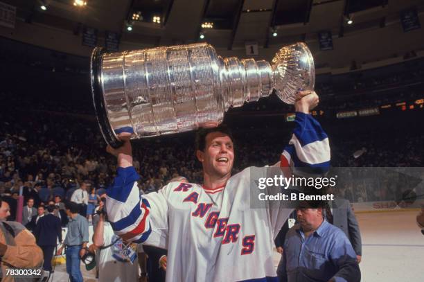 Canadian ice hockey player Craig MacTavish of the New York Rangers holds aloft the Stanley Cup on the ice after his team's victory in the finals, New...