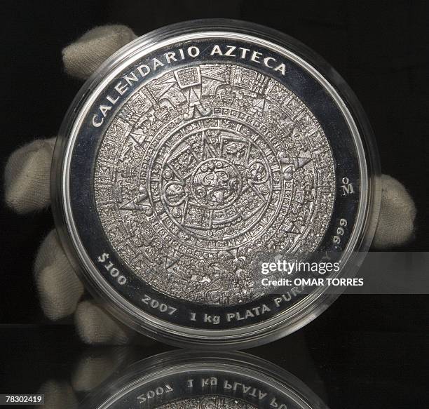 The conmemorative silver coin "Calendario Azteca " is shown during the presentation ceremony at the Anthropology Museum in Mexico City, 06 December...