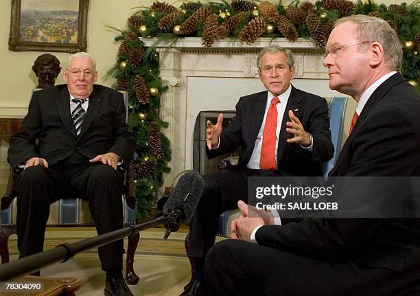 President George W. Bush speaks as he sits with Northern Ireland's First Minister Ian Paisley and deputy First Minister Martin McGuinness during a...