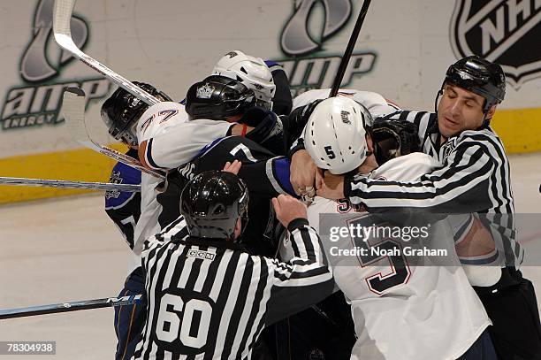 Linesmen Pat Dapuzzo and Derek Amell attempt to seperate Ladislav Smid of the Edmonton Oilers and Derek Armstrong of the Los Angeles Kings during the...