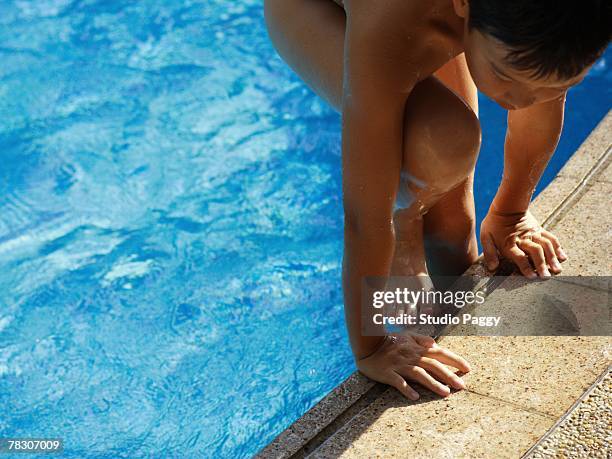 high angle view of a boy coming out of a swimming pool - 胴上げ ストックフォトと画像