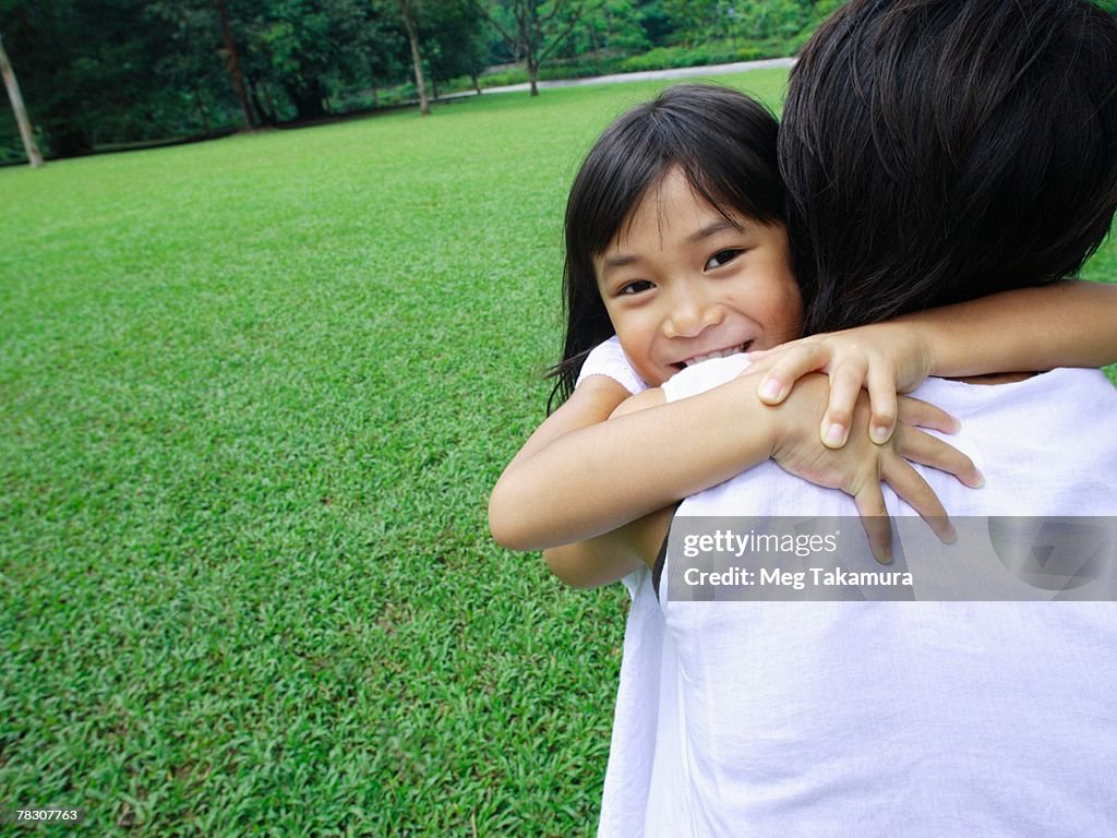 Close-up of a girl embracing her mother