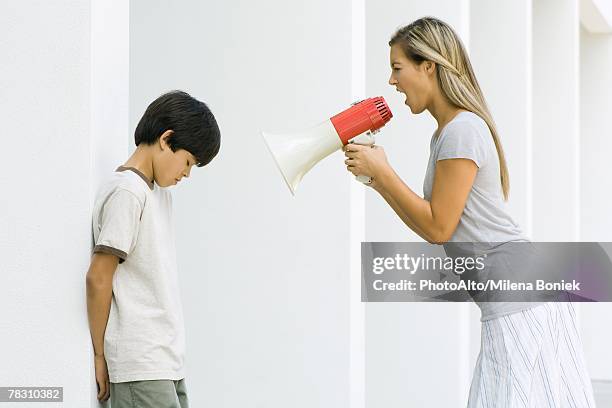 woman shouting at boy through megaphone - mother scolding stock pictures, royalty-free photos & images