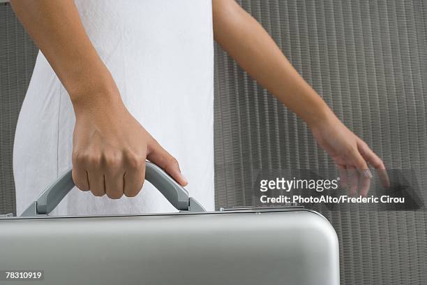 woman walking and carrying briefcase, cropped view of hands - carry on luggage photos et images de collection