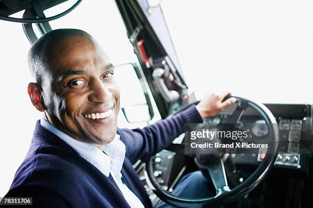bus driver at steering wheel - busfahrer stock-fotos und bilder