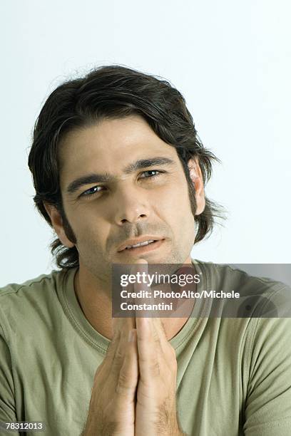 man pleading with hands together, looking at camera, portrait - southern european descent stock pictures, royalty-free photos & images