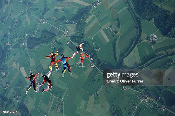 skydivers in formation - skydiving pov stock pictures, royalty-free photos & images