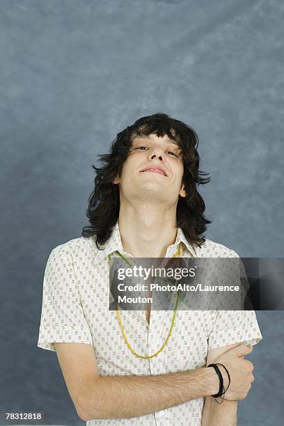 teenage boy with arms folded, head back, looking at camera - boy with long hair stock pictures, royalty-free photos & images