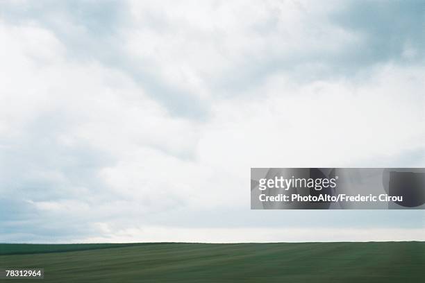 green field and cloudy sky - horizon over land imagens e fotografias de stock