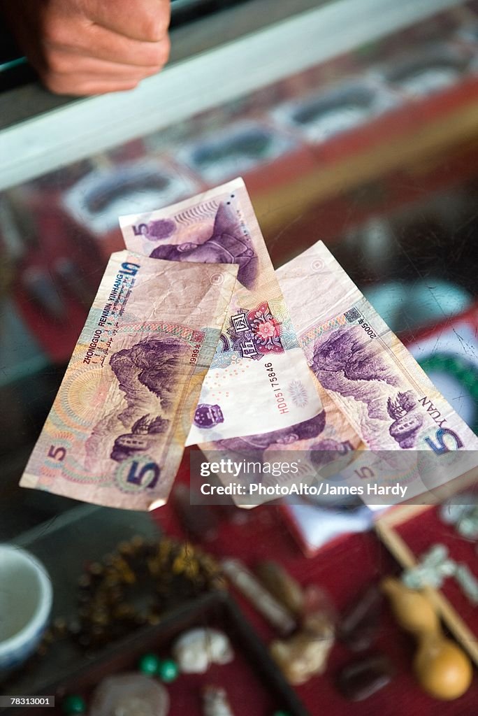 5 Yuan banknotes on counter