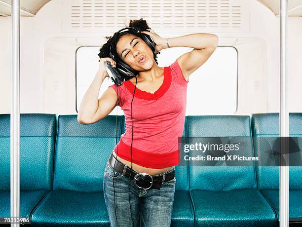 woman dancing on bus - personal compact disc player 個照片及圖片檔