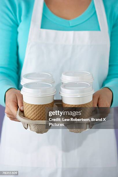 woman with coffee in takeout tray - takeout coffee tray stock pictures, royalty-free photos & images