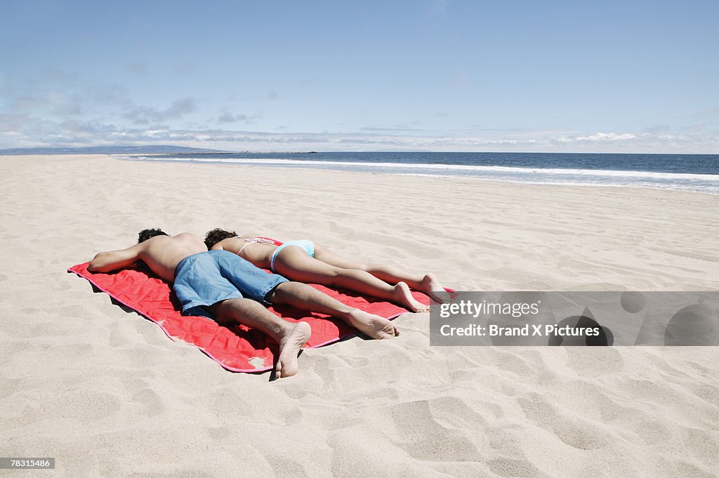 Couple lying on beach