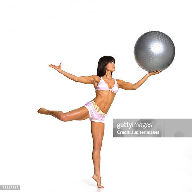 woman balancing exercise ball - boyshorts stockfoto's en -beelden